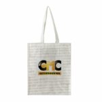 sac publicitaire blanc avec texte gris et logo CMC accessoires noir et jaune